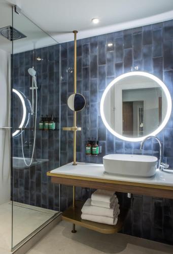 a bathroom with a sink and a mirror at Crowne Plaza - Nice - Grand Arenas by IHG in Nice