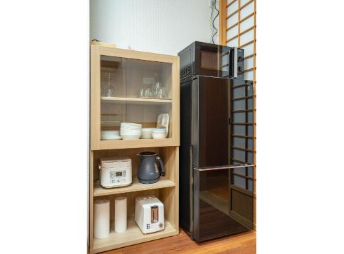 a kitchen with a black refrigerator in a room at Japanese traditional house.Ryokan in asakusa with 2bedrooms in Tokyo