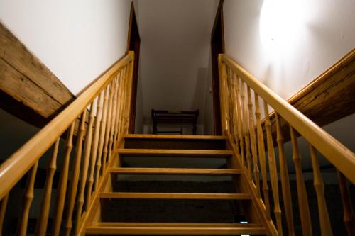 a staircase with wooden railings in a building at Penzion Květná Zahrada in Květná