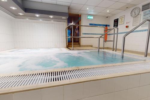 a large pool of water in a room at Village Hotel Manchester Hyde in Hyde