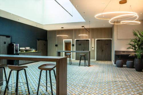 an office lobby with a bar and stools at Crowne Plaza - Nice - Grand Arenas by IHG in Nice
