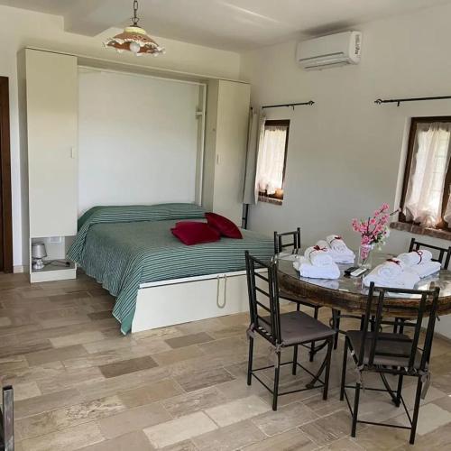 a bedroom with a bed and a table and chairs at Dimora dei Cardinali in Agropoli