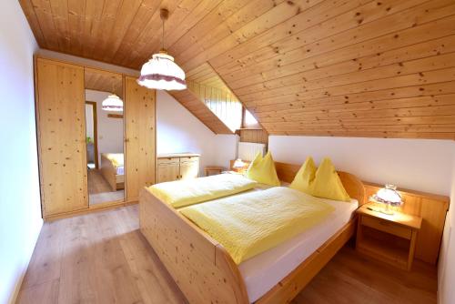 a bedroom with a large bed in a wooden ceiling at Marolhof in Cornaiano