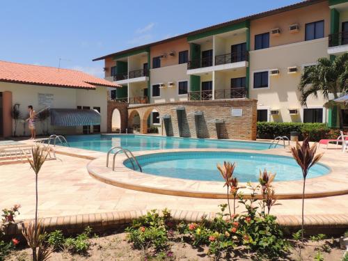 a swimming pool in front of a building at Ap Luxo 208 e 207 Prox Beach Park in Aquiraz