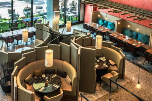 an overhead view of a restaurant with tables and chairs at Crowne Plaza - Nice - Grand Arenas by IHG in Nice
