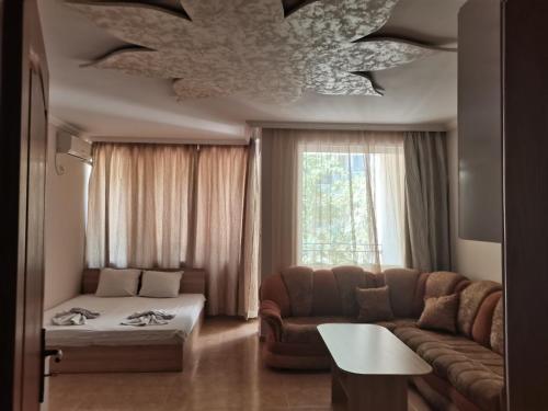 a living room with a couch and a chandelier at Apartment See Breeze in Sunny Beach