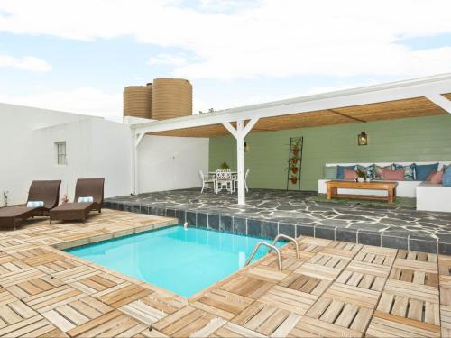 a house with a swimming pool and a patio at Bains View Olive and Guest Farm in Wellington
