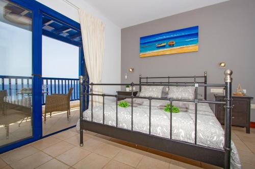 a bedroom with a bed and a balcony at Atlantis in Puerto Calero