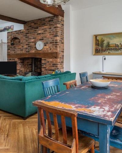 a table and chairs in a living room with a couch at The Old Fire Station Ludlow in Ludlow