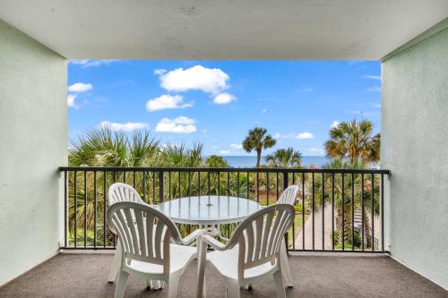 a balcony with a table and chairs and the ocean at 2-Bedroom Carolina Dunes Condo with Private Balcony and Ocean Views in Myrtle Beach