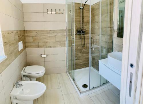 a bathroom with a shower and a toilet and a sink at B&B Birillo in Cariati