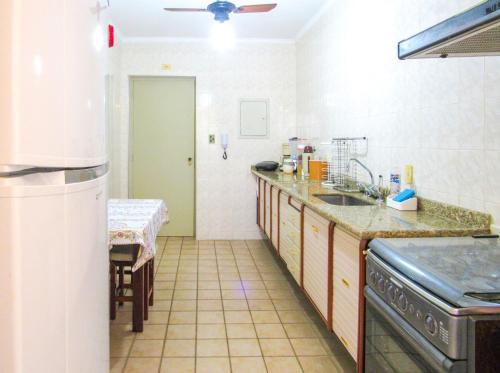 a kitchen with a sink and a stove at Apto a 600 metros da Praia Grande em Ubatuba SP in Ubatuba