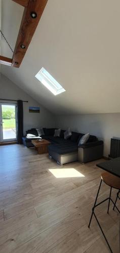 a large living room with a couch and a window at Rucastle Apartment in Ingleton