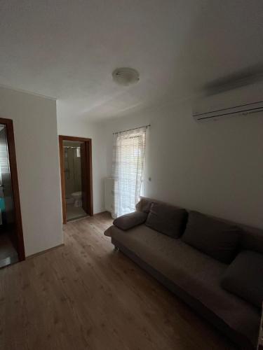 a living room with a couch and a window at Apartmani Mia in Drage