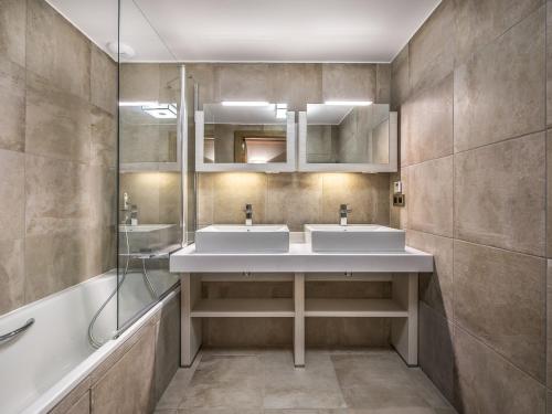 uma casa de banho com 2 lavatórios e um chuveiro em Appartement Courchevel 1550, 3 pièces, 4 personnes - FR-1-562-23 em Courchevel