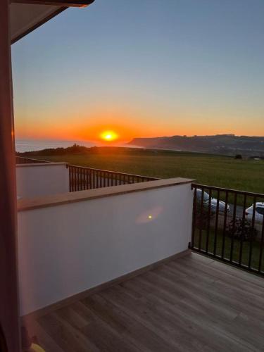a sunset from the balcony of a house at El Ribero de Langre in Langre