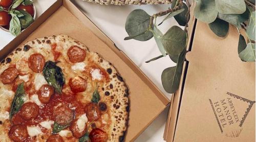 two pizzas in a box on a table at The Abbeyleix Manor Hotel in Abbeyleix