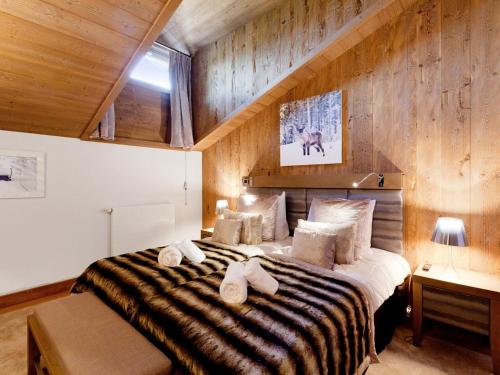 a bedroom with a large bed with towels on it at Appartement Courchevel 1550, 5 pièces, 12 personnes - FR-1-562-58 in Courchevel
