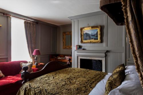 a bedroom with a bed and a fireplace at Hazlitt's in London