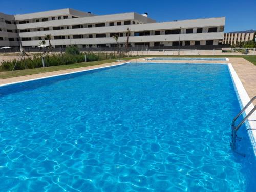 a large swimming pool in front of a building at Ca La Cristina - Apartamento Turístico L'Ametlla de Mar in L'Ametlla de Mar