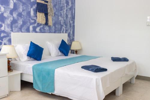 two beds in a room with blue and white at Bohemian Villa - Negombo in Negombo