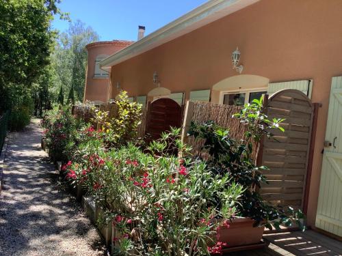 a house with a bunch of flowers in front of it at La Morandiere in Grayan-et-lʼHôpital