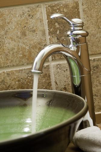 a bathroom sink with water coming out of a faucet at Golden Stage Inn in Proctorsville