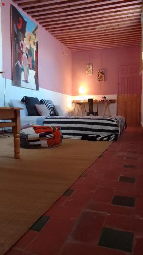 a room with two beds and a table in it at Tarbi'aat Tetaoun 44, 17th century heritage in Tetouan