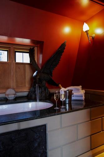 a bathroom with an eagle statue next to a sink at Hazlitt's in London