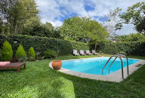 a swimming pool in the middle of a yard at ROOM in Molhe house with pool in Porto