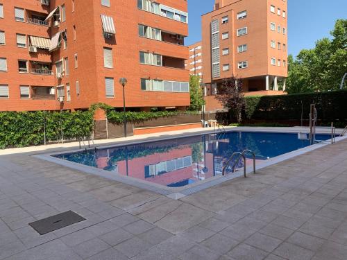a swimming pool in front of some tall buildings at Apartamentos Torr Zona Caja Mágica, Hospital 12 de Octubre - Con Garaje Incluido in Madrid