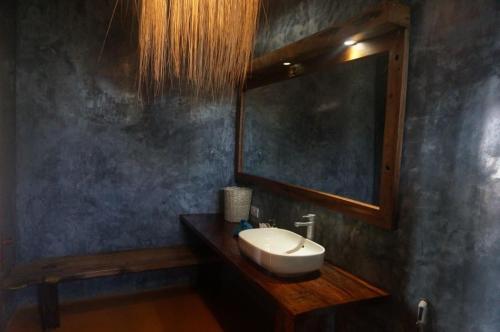 a bathroom with a sink and a mirror at White Sands in Paje