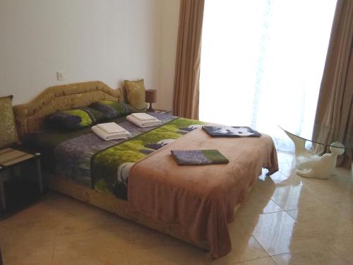 a bedroom with a bed with towels on it at LUČICE - 2024 - PETROVAC, Prijevorac, BB - Apartment - OXANA - Stan 1 in Petrovac na Moru