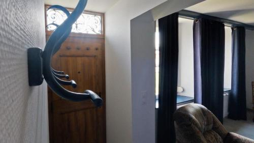 a door with a whale head on a wall at Le chat Moustic in Rarécourt