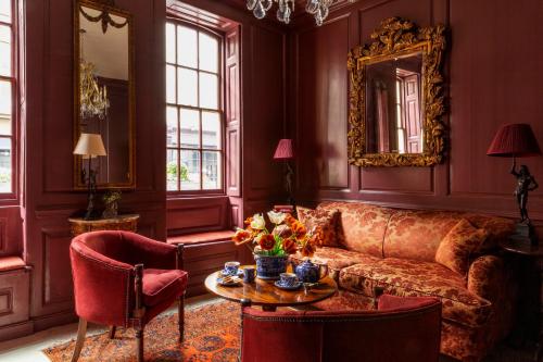a living room with a couch and a table at Hazlitt's in London