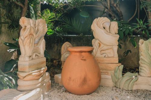 an orange vase sitting next to a group of statues at Maison d'artistes - Pavillon Southway in Marseille