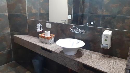 a bathroom with a sink and a mirror at Apart , Descanso y Bienestar in San Pedro