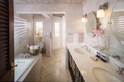 a bathroom with two sinks and a large mirror at Round Hill Hotel & Villas in Montego Bay