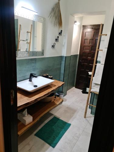a bathroom with a sink and a mirror and a ladder at B&B Finca la Yuca "Un paraíso en Ontinyent" in Ontinyent