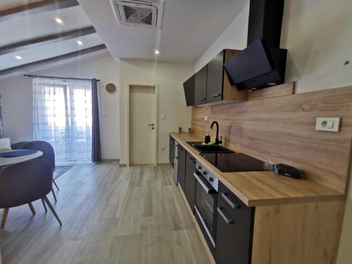 a kitchen with a sink and a counter top at New Nikolina 4 star in Mali Lošinj