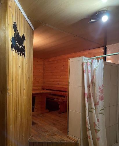 a room with a sauna with a shower curtain at Садиба "ЯНА" in Slavske