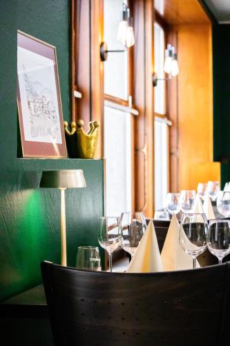 a table with wine glasses on it in a restaurant at Auberge Communale de la Couronne in Yvorne