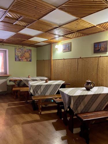 a row of tables in a room with a ceiling at Садиба "ЯНА" in Slavske