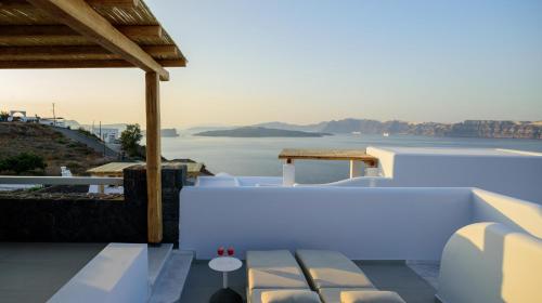 a white house with a view of the water at Acro Blue Luxury Villas in Akrotiri