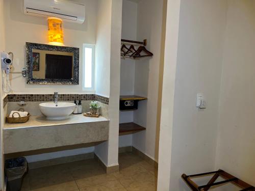 a bathroom with a sink and a mirror at Hotel Balché in Bacalar