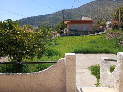 a view of a hill with a house in the background at MAGNIFICENT SEA VIEW HOUSE in Methana
