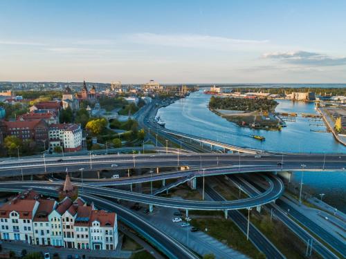 a city with a bridge over a river and buildings at Apartamenty Silver Place in Szczecin