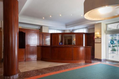 a courtroom with wood paneling and a podium in a building at Hotel Hoyuela in Santander