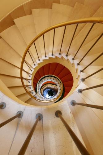 a spiral staircase in a building at Hotel Hoyuela in Santander