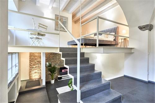 a room with a staircase with a bed in it at ASTRA-Modern Loft Cathedral View in Bergamo